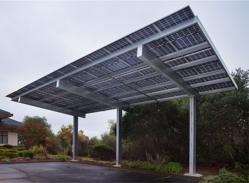 Solar carport support structure in commercial parking lot