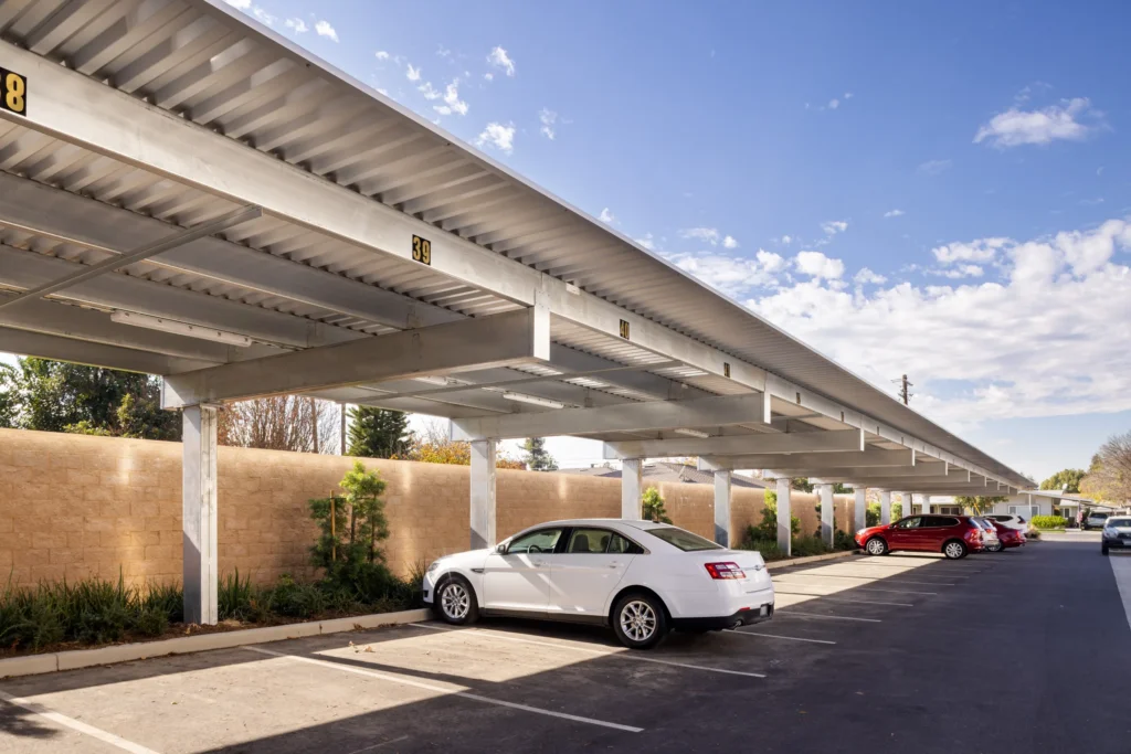 Shade carport structure in multifamily residential parking lot
