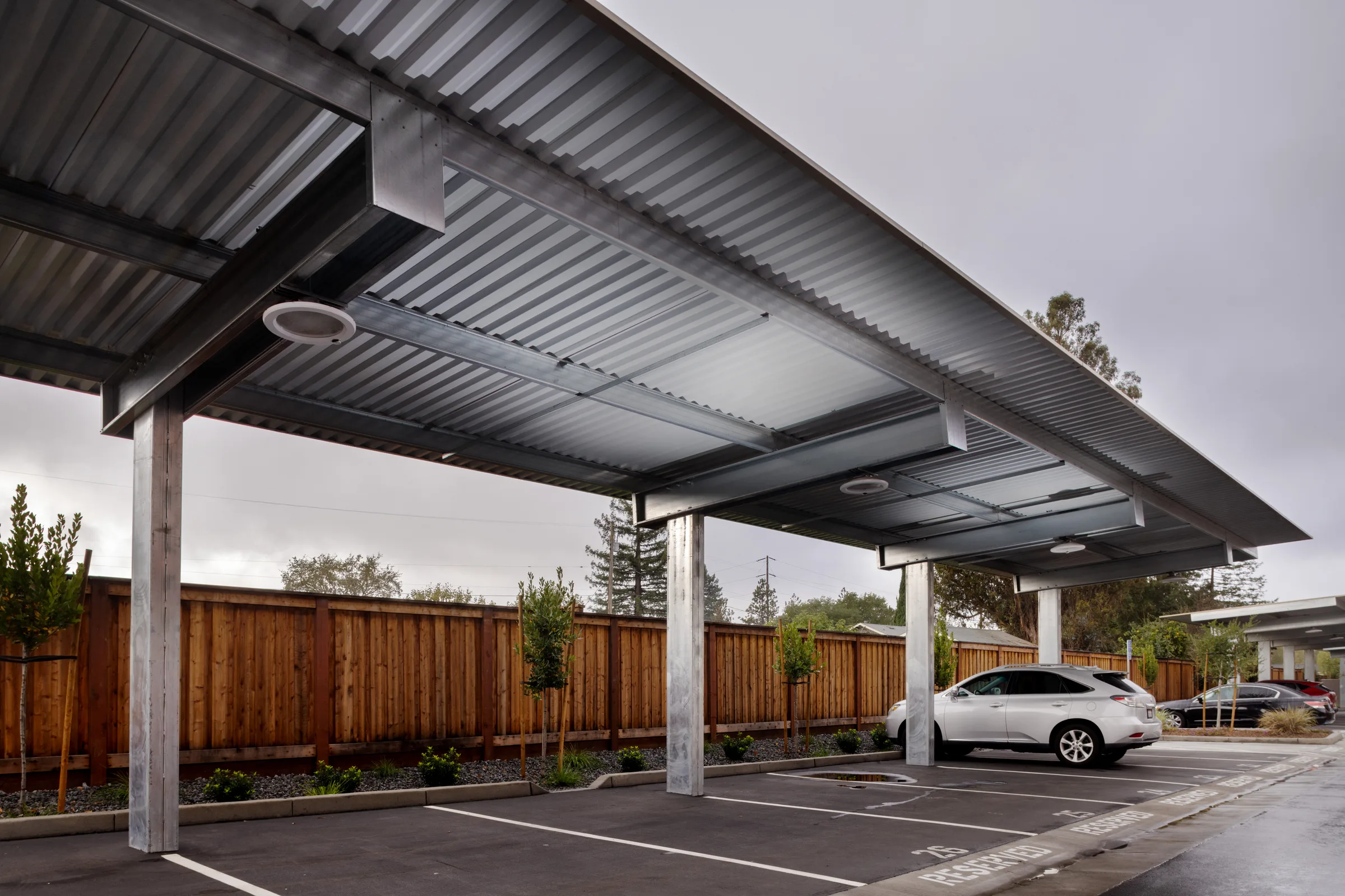 Shade carport structure in multifamily residential parking lot