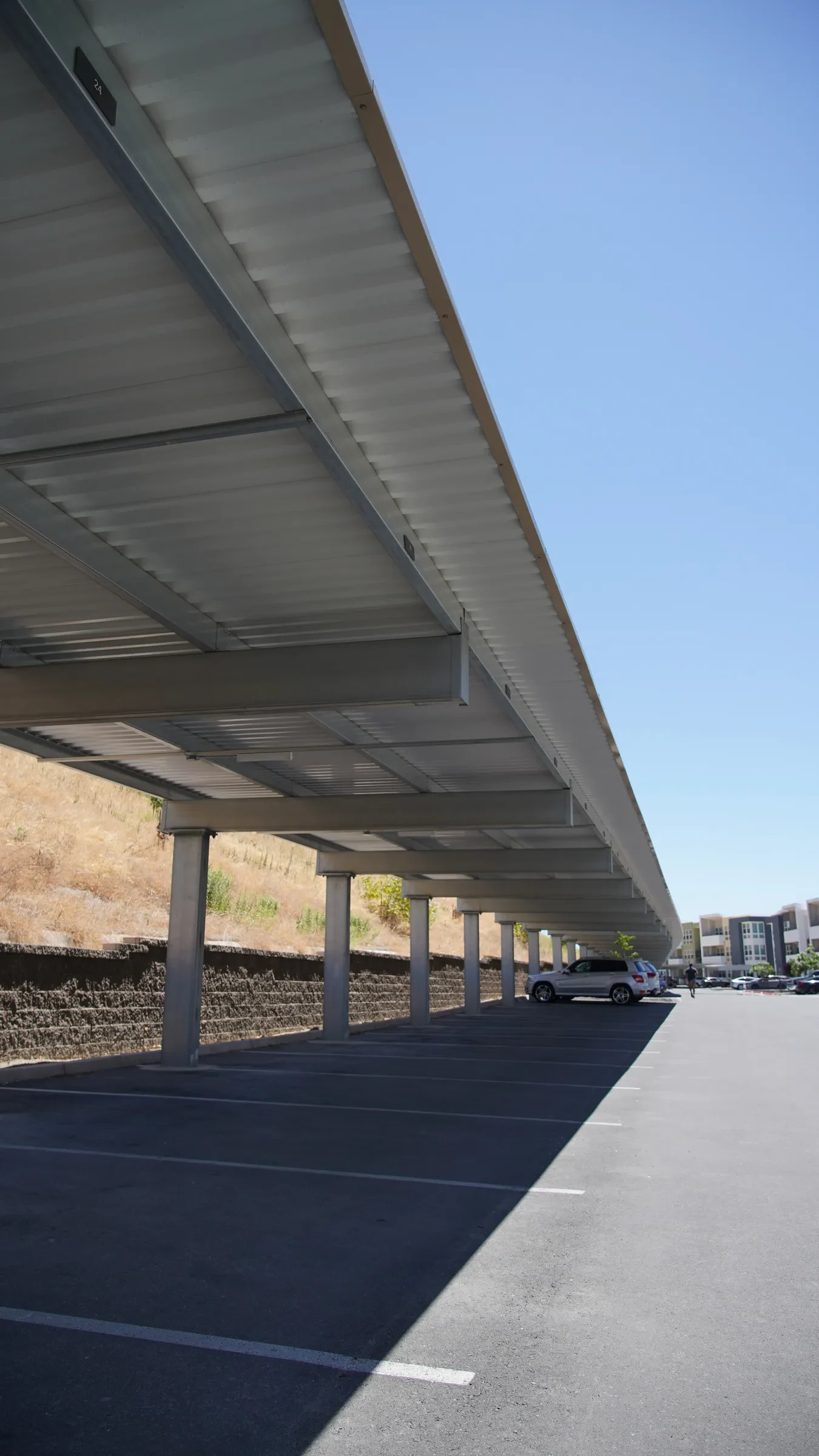 Shade carport structure in multifamily residential parking lot